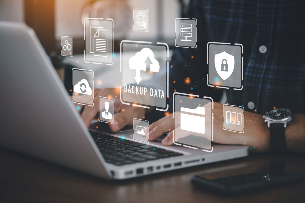 Businessman using a computer to backup storage data Internet tec AdobeStock 497213563 scaled 1